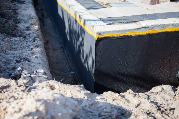 Professional Basement Waterproofing technician working in Oakwood, GA